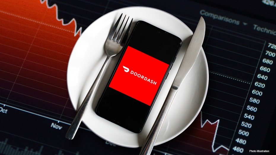Doordash app on a phone that is on top of a plate