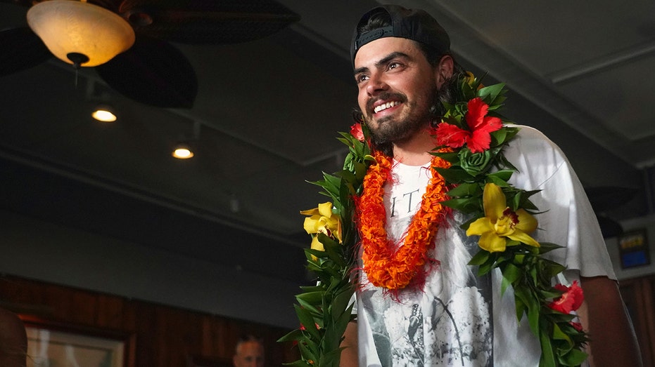 Oliver Widger smiling with leis