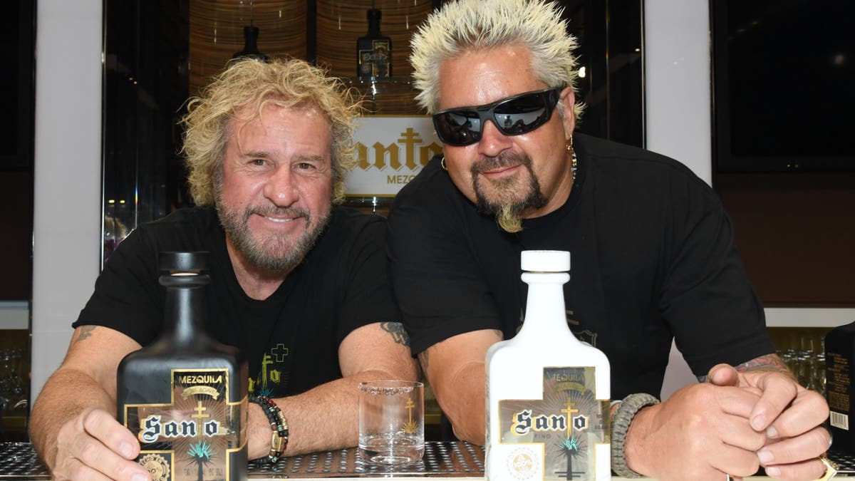 guy fieri and sammy hagar pose with santos bottles