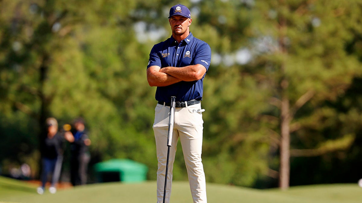 Bryson DeChambeau with arms folded